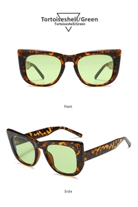 Detail view showing tortoiseshell oversized cat-eye sunglasses with gradient green lenses