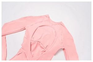 Detail of pink long-sleeve yoga bodysuit with oval back cutout and built-in bra padding