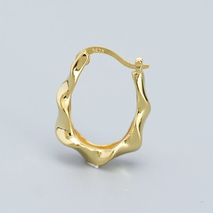 Chic 925 silver irregular golden hoop earrings with wavy texture on grey background