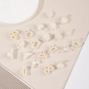Detailed view of mini pearl hair clips in heart, flower, and butterfly shapes