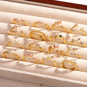 Bagues dorées élégantes avec papillons et fleurs en cristaux étincelants dans un coffret