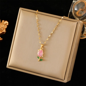 Elegant gold tulip necklace with pink teardrop crystal and green leaf accents