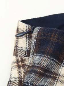Detailed macro view of the plaid fabric texture and invisible zipper on the camisole