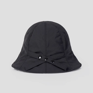 Close-up of black quick-dry sun hat with cross strap detail and three round buttons