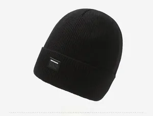 Detailed side view of black ribbed knit beanie showing textured fabric and mountain logo patch