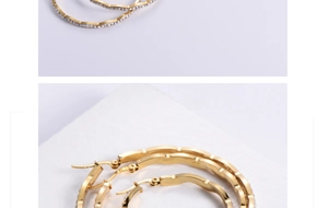 Close-up of 18K gold-plated wavy hoop earrings with pavé set rhinestones and secure clasp