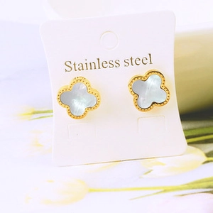 Detail of four-leaf clover stud earrings with white mother of pearl inlay in gold steel