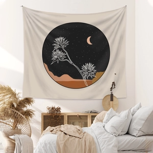 Detail of Boho wall tapestry with cactus and moon illustration in a cozy bedroom setting