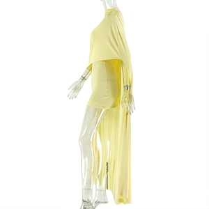 Detail view of bright yellow sleeveless dress featuring elegant pleated drape and shawl design