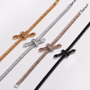 Detail of knotted tennis bracelets featuring zircon stones in gold silver rose gold and black