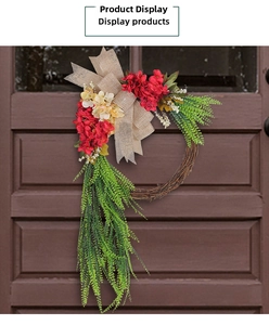 Detail of rustic floral wreath with burlap bow and artificial greenery on wood door