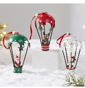 Close-up of metal Christmas hot air balloon ornaments with Santa, elk, and snowman motifs