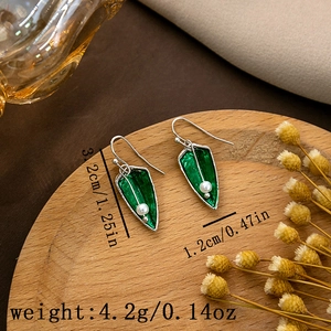 Detail view of green rhombus earrings with white pearls and precise size measurements