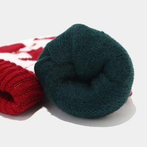 Macro shot of the thick inner fleece lining and festive knit pattern on the winter set