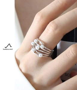 Close-up of vintage wave pattern silver ring with white pearls in stainless steel