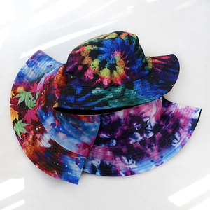 Starry sky and tie-dye printed bucket hats stacked on a minimalist white background
