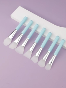 Set of 7 blue silicone face mask brushes with different heads for spa facial treatments