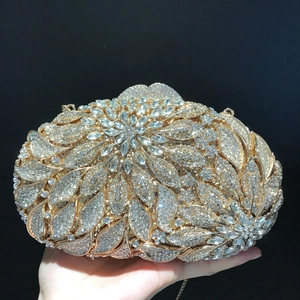 Close-up of golden leaf pattern evening clutch bag with sparkling crystal rhinestones