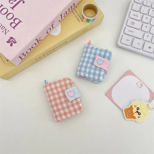 Detail of mini gingham photo albums with quilted fabric and heart-shaped buttons