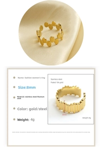 Detailed spec view of 8mm wide 18k gold plated stainless steel rings with stripe texture