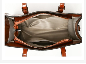 Internal view of brown faux crocodile handbag showing spacious lining and zipper pocket