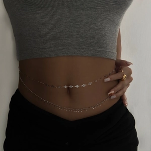 Close-up of double-layer silver waist chain with diamond charms and tassel fringe