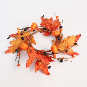 Close-up of fall wreath featuring maple leaves, mini pumpkins, and black berries