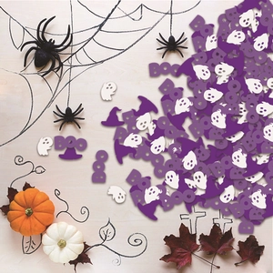 Halloween party confetti with purple BOO letters, ghosts, and witch hats on wood