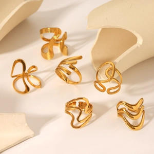 Detailed view of 18K gold plated stainless steel rings with irregular wave designs