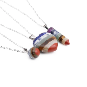Colorful crystal stone necklaces with heart, sphere, and prism pendants on silver chains