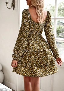 Detail of green floral dress back showing square neckline and ruffled layered hemline