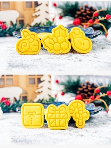 Detailed view of six golden baked Christmas cookies with festive reindeer and holly shapes