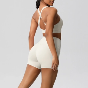 Detail of cross-back yoga bra and high-waist shorts in cream white sports set