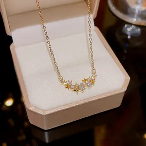 Close-up of a gold star necklace with sparkling zircon stars in a jewelry gift box