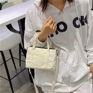 Vintage white corduroy Boston handbag for women with small front pocket and shoulder strap