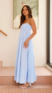 Full view of casual blue and white striped camisole maxi dress with open back and pockets