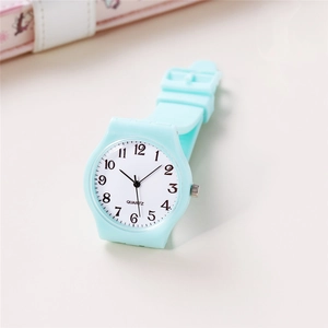 Macro detail of mint green silicone strap and white dial with black numeric indexes