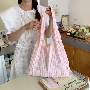 Pink and white checkered canvas tote bag with a spacious interior and soft fabric texture