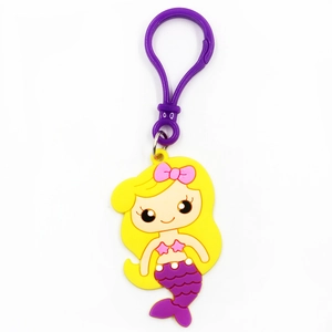 Close-up of a cartoon mermaid keychain featuring yellow hair and purple tail detail