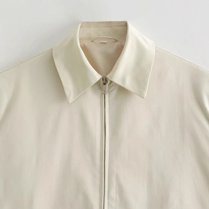 Giacca da donna minimalista color crema con cerniera, colletto a revers e tessuto liscio