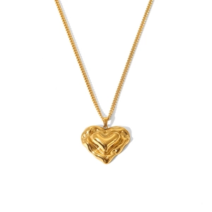 Macro detail of golden heart pendant with irregular liquid texture on a curb chain