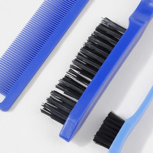 Detailed view of 3-piece hair styling set with blue plastic handles and black bristles