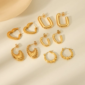 Collection of golden geometric earrings featuring heart, star, and U-shaped metal designs