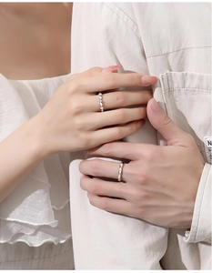 Close-up of S925 silver couple rings with geometric diamond setting on hands