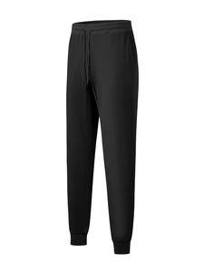 Detail of black waffle knit pants showing drawstring waist and breathable fabric texture