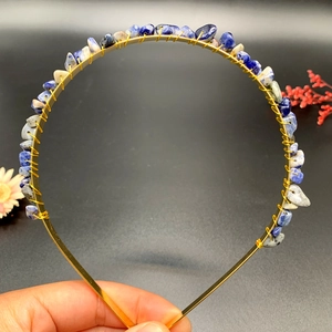 Detailed macro view of handmade crystal stone crown headband with gold wire wrapping