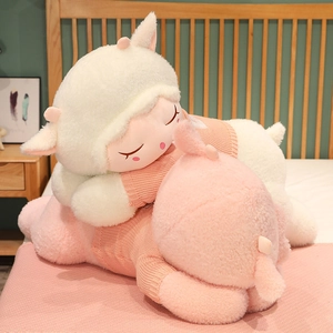 Detailed view of soft lamb plush toys in white and pink wearing knit sweaters in bedroom