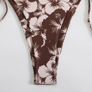 Close-up of tropical hibiscus print fabric and tie-side detail on a bikini bottom