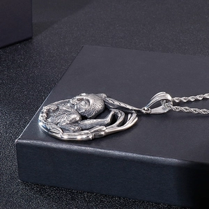 Close-up of vintage tiger and panda animal pendant with bamboo motif on rope chain