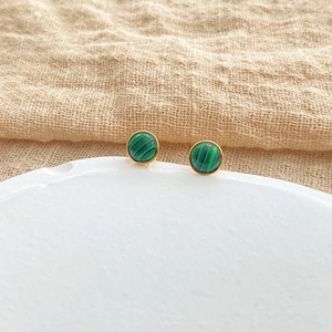 Malachite stud earrings with 18k gold plating on elegant white gypsum tray background